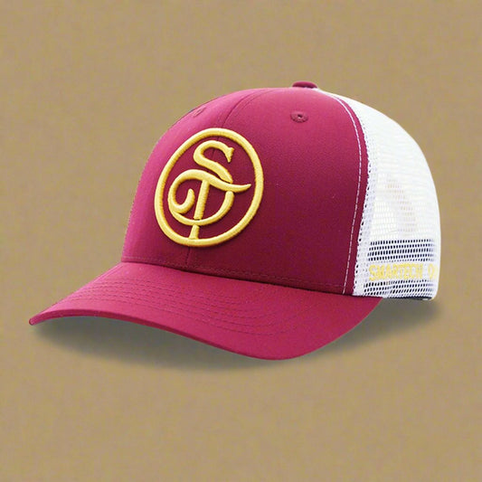 The Smartech Outfit Burgundy Trucker Mesh Cap is a premium cap featuring a burgundy and white design with a yellow embroidered logo of intertwined letters on the front. It offers a mesh back for ventilation, an adjustable snapback closure, and UV light protection for extra durability.