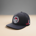 Black 5G logo snapback cap on a premium warm stone studio background